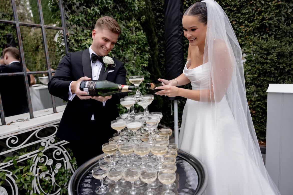 Champagne tower at a Melbourne wedding Bride and groom pouring a champagne tower at their Melbourne wedding