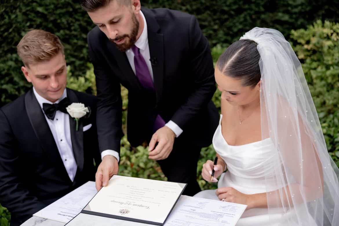 Signing the marriage certificate Couple signing their marriage certificate with celebrant John Edney