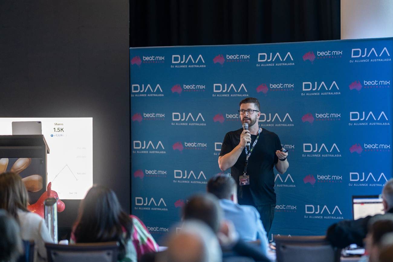 John Edney hosting a conference on stage as event host and MC