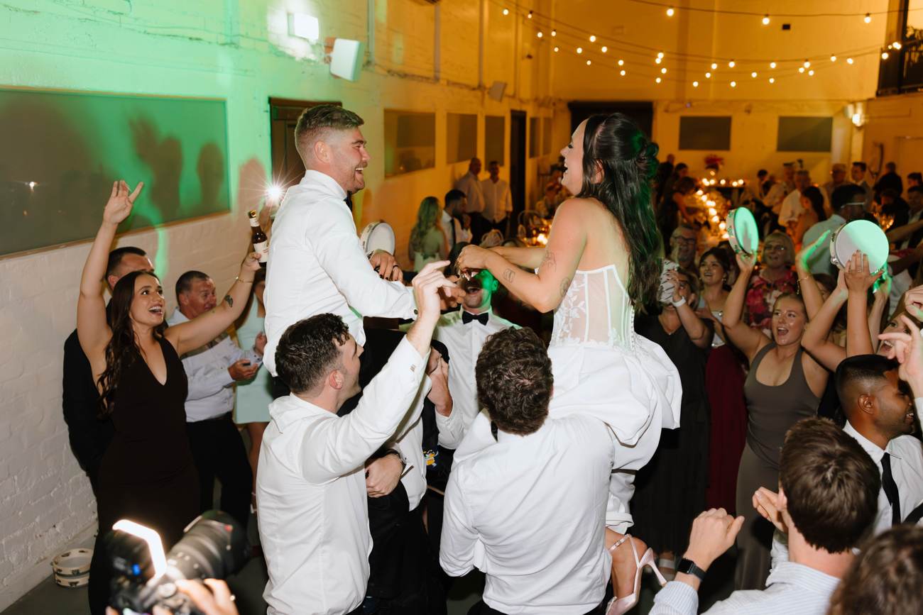 Full dance floor at a Melbourne wedding reception with live DJ mixing