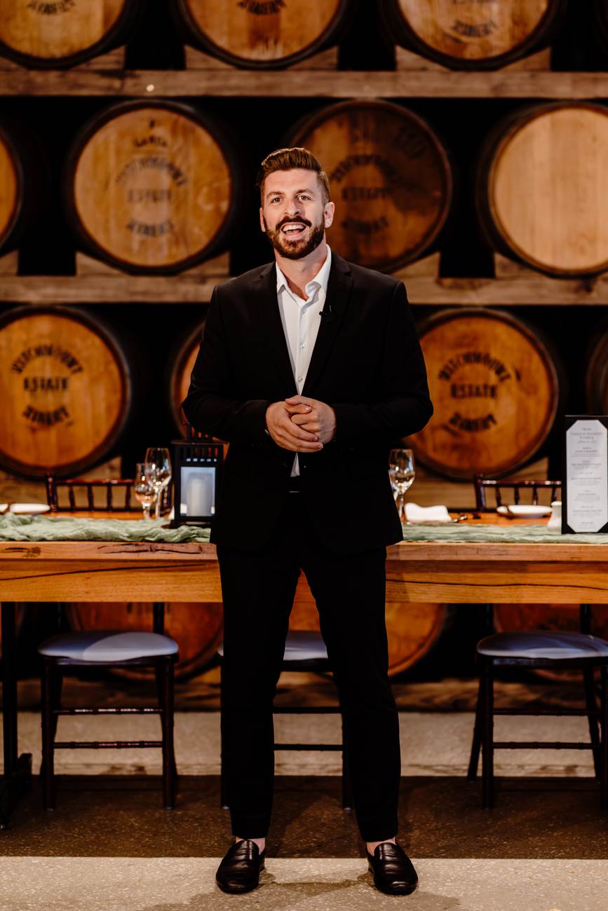 John Edney, Melbourne wedding celebrant, DJ and MC John Edney, Melbourne wedding celebrant, DJ and MC, standing in a winery barrel room