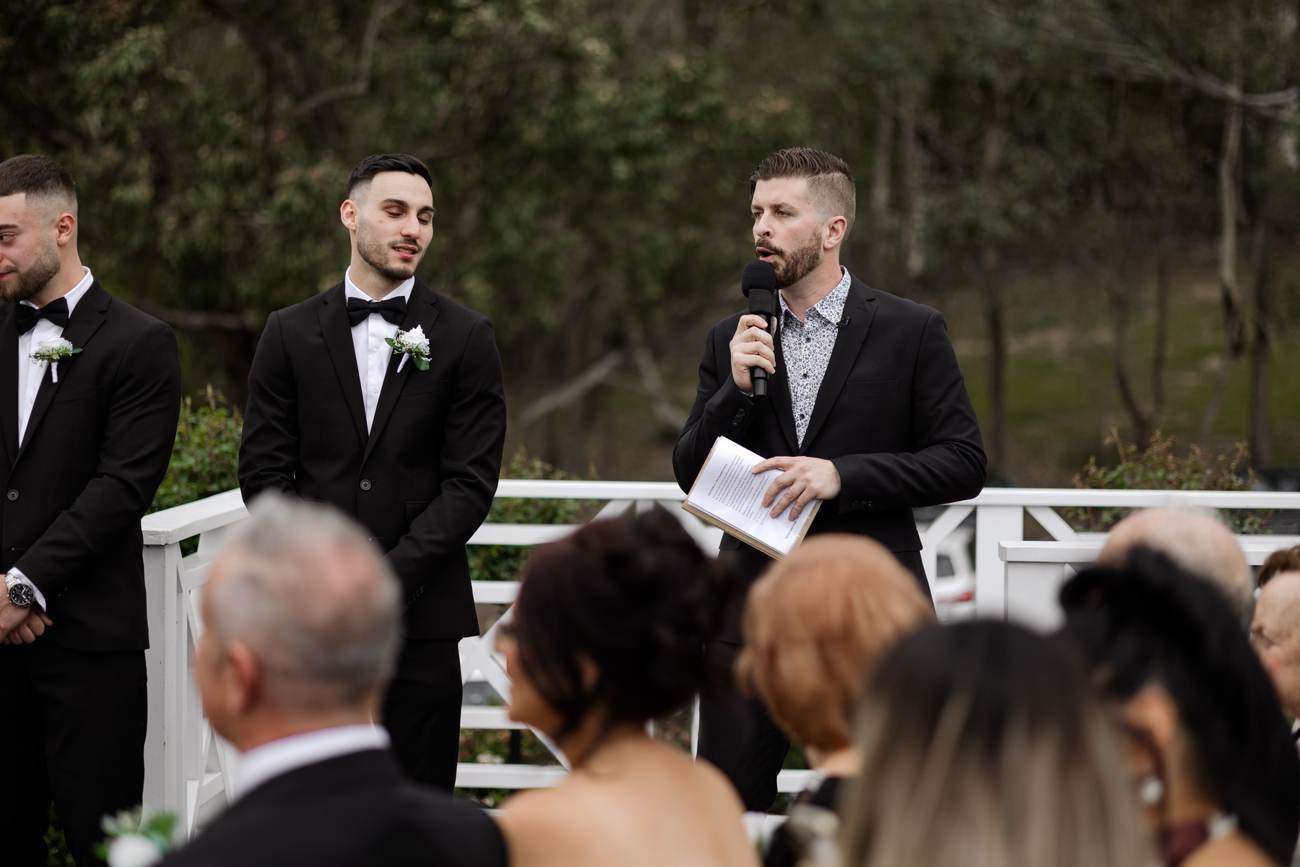 John Edney officiating a Melbourne wedding John Edney officiating a wedding ceremony beside the groomsmen