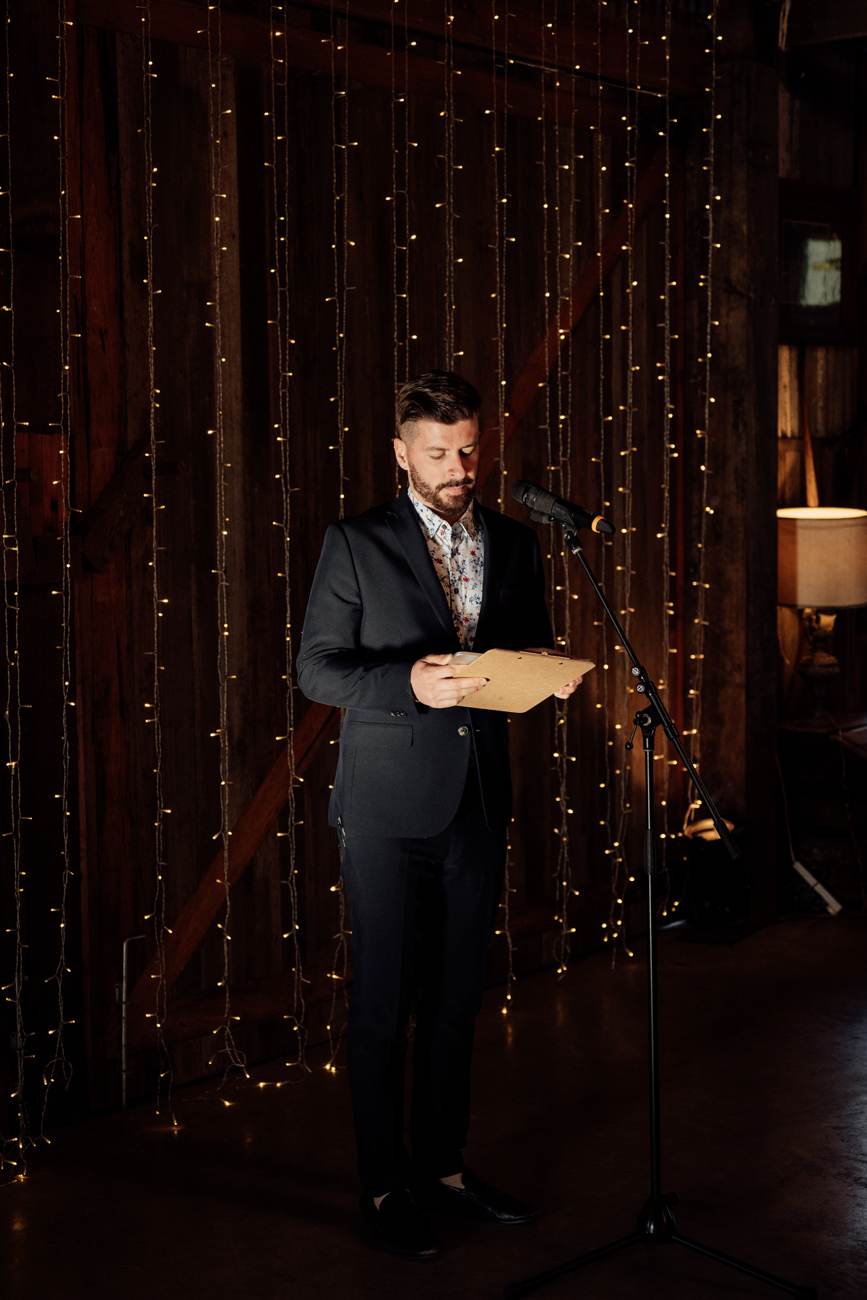 John Edney at the lectern running wedding reception formalities as MC